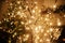 Stylish christmas illuminated tree on background of golden lights bokeh, decorated tree and burning fireplace in evening room.