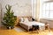 Stylish Christmas interior , bedroom with a lot of lights. Comfort home. Christmas decorated room in loft style