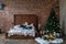 Stylish Christmas interior, bedroom with a lot of lights. Comfort home in a loft style with a decorated Christmas tree and a