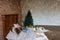 Stylish Christmas interior, bedroom with a lot of lights. Comfort home in a loft style with a decorated Christmas tree and a