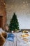 Stylish Christmas interior, bedroom with a lot of lights. Comfort home in a loft style with a decorated Christmas tree and a