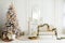 Stylish Christmas light interior with a soft armchair or sofa decorated with garland