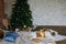 Stylish Christmas loft interior,cozy bedroom with wooden bed and a lot of lights with a decorated Christmas tree and a
