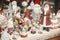 Stylish Christmas souvenirs, santa clauses, snow globes, snowman toys in showcase of festive store. Modern christmas decor in city