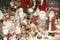 Stylish Christmas souvenirs, santa clauses, snow globes, snowman toys in showcase of festive store. Modern christmas decor in city