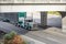 Stylish classic American white and green semi truck tractor transporting cargo in black covered semi trailer with front wall