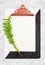Stylish clipboard with blank paper sheet and green plant