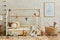 Stylish composition of cozy scandinavian child`s room interior with wooden bed, plush and wooden toys, rattan basket and textile.