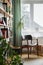 Stylish composition of home office interior with design retro chair, home library, plant, window, books, decoration