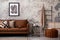 The stylish composition of living room interior with mock up poster frame, brown sofa, patterned pillow, modern pouf and personal