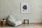 Stylish composition of minimalistic living room interior with mock up poster frame, grey pouf, black tiny coffee table, wooden.