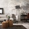 The stylish compostion at concrete living room interior with design gray sofa, wooden coffee table, desk and elegant personal