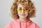 Stylish and cool partying girl. Portrait of relaxed fashionable woman with curly blond hair wearing trendy round