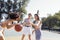 Stylish cool teen girls gathering at basketball court, friends playing basketball outdoors