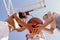 Stylish cool teen girls gathering at basketball court, friends playing basketball outdoors