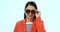 Stylish, cool and a woman with sunglasses on a studio background for fashion, confidence and a trip. Happy, trendy and a