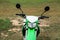 Stylish cross motorcycle on green grass outdoors