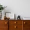 Stylish decorations on retro style sideboard, close-up