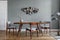 Stylish dining room with wooden table and vintage chairs.