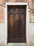 Stylish door in a concrete wall in Venice city, Italy