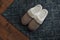 Stylish door mat and slippers on wooden floor, top view