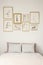 Stylish drawings gallery in golden frames above a cozy double be