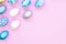 Stylish Easter Corner Frame background with silver and blue easter eggs on pink background. Mockup, top view