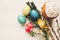 Stylish easter eggs and easter bread cake and flowers on wooden