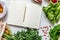 Stylish eco composition on the marble table with mock up notebook, zero waste neutral bags, seeds, eggs, herbs, bio vegetables.