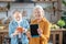 Stylish elderly woman showing her tablet in the blue case