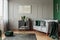 Stylish emerald green and grey living room interior design with abstract painting on the wall