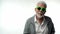 Stylish emotional old man pensioner with a gray beard in green glasses dances with funny emotions on a white isolated