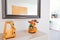 Stylish entrance hall of a modern flat decorated with a mirror, a candle and a soft toy in the shape of a reindeer to leave the
