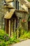 stylish entrance to a residential building, an interesting facade of the old stone wall, old wooden door,  typical old English bu