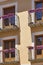 Stylish facade with traditional balconies and purple pots. Brihuega, Spain