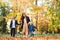 Stylish family on a walk. Mother with two children having fun outdoors in cool autumn weather. Fashion, lifestyle and family