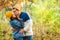 Stylish fashion couple kissing outdoors in autumn. First kiss. Sensual young couple walking in autumn park. Romantic first date