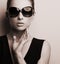 Stylish fashion female model in fashion sunglasses posing. Black