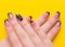 Stylish fashionable female manicure on a yellow background