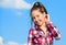 Stylish fashionable kid. Kids fashion concept. Kid girl checkered fashionable shirt posing sunny day blue sky background