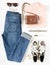 Stylish female clothes set. Woman/girl outfit on white background. Blue jeans, print sneakers, vintage camera, pink t-shirt, hand