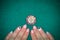Stylish female poker manicure and chip from casino Marina Bay Sands Singapore on a green background. Life is a game. Singapore -
