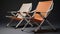 Stylish Folding Chairs In Light Orange And Bronze On Gray Background