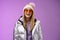 Stylish friendly charismatic blond woman in silver shiny jacket hat sunglasses ready learn snowboarding smiling laughing
