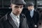 Stylish gangsters men, posing on background of railway. england