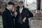 Stylish gangsters men, smoking. posing on background of railway