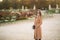 Stylish girl in coat posing for photographer. Park