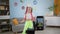 stylish girl with colorful pigtails records video on mobile phone at home, blogger child shoot new trend for internet