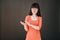 Stylish girl in glasses stands on a black background and claps her hands