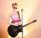 Stylish girl guitarist singer in pink glasses with black guitar, vintage microphone. Teenager musician in funny vintage